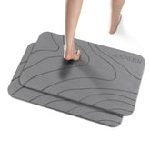 JUERLEN esterilla vista frontal con diseño ondulado gris y aspecto piedra, absorción rápida