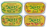 Nuri frontal del pack de cuatro latas mostrando variedad y presentación artesanal