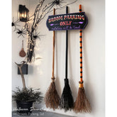 ORIENTAL CHERRY front view of broom parking sign adds playful Halloween charm