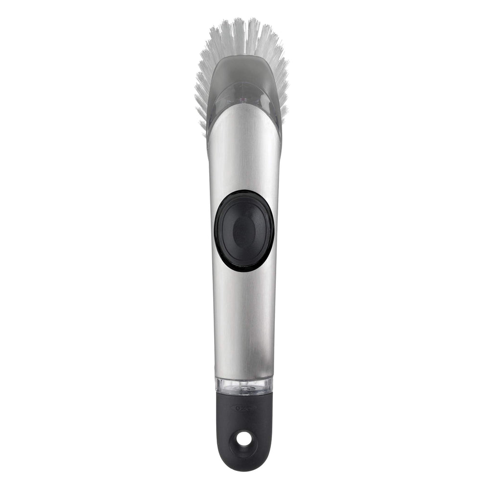 OXO cepillo frontal con mango mostrando diseño ergonómico y dosificación de jabón