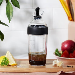 OXO Good Grips junto a una taza para comparar tamaño y capacidad compacta