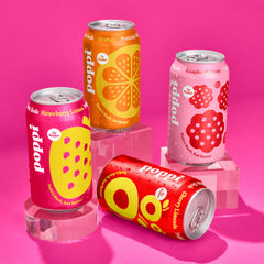 poppi in use on picnic table with glasses, brand serving convenience and social use