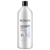Redken Acidic Bonding Concentrate shampoo frente del envase mostrando tamaño profesional y beneficio de reparación