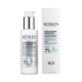 Redken serum en envase frontal mostrando diseño y beneficio reparación