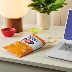 several SkinnyPop bags tucked inside a lunchbox demonstrating convenient school-ready portions