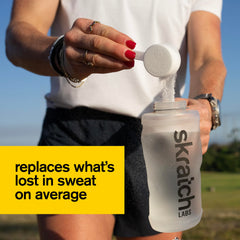 Skratch Labs tub open with powder visible, easy scoop access benefit