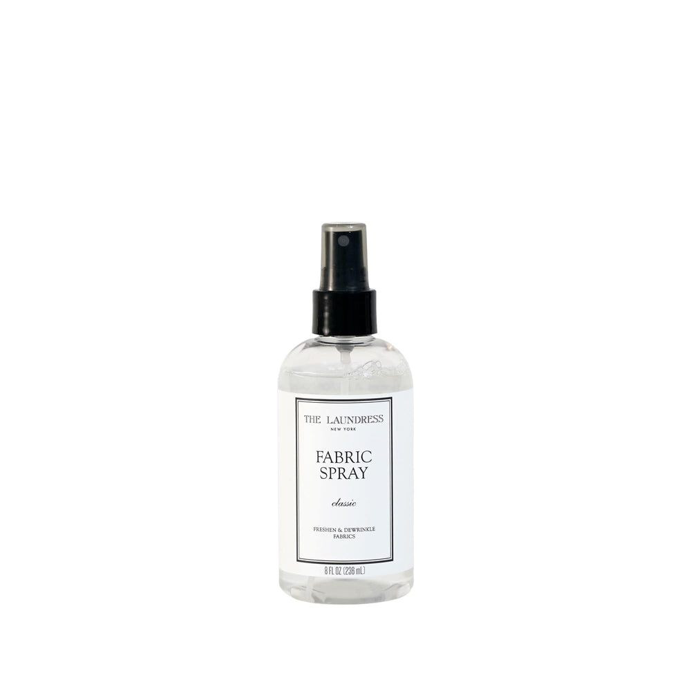 The Laundress spray frontal mostrando botella elegante y beneficio de frescura