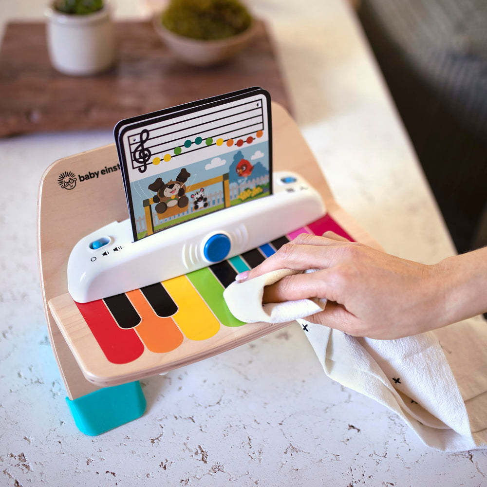 Baby Einstein piano boxed packaging and label highlighting included music sheets and specs