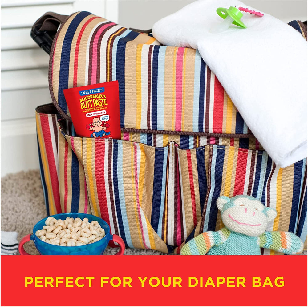 Boudreaux's Butt Paste comparación de tamaño 2oz y 14oz junto a pañal