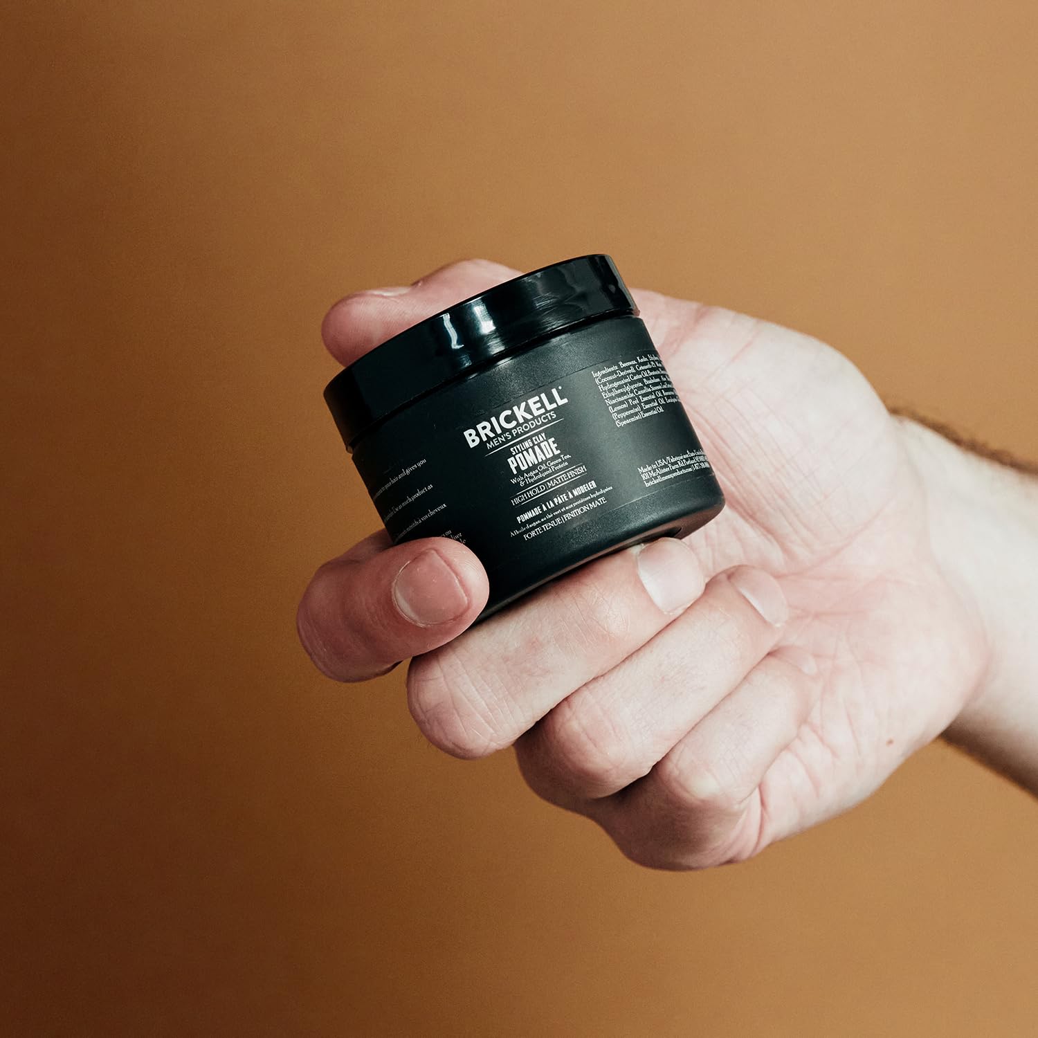 Brickell Men's Products being applied to hair demonstrating styling control and texture
