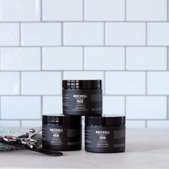 Brickell Men's Products open jar with visible cream and ingredient focus for conditioning