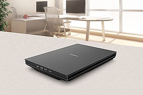 Canon CanoScan LiDE 300 al lado de laptop, tamaño compacto para escritorio