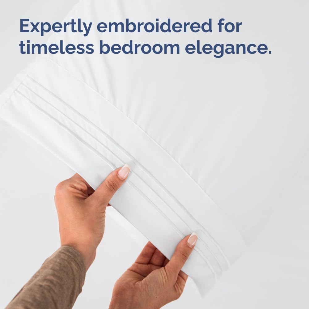 CGK Unlimited ambiente de dormitorio con fundas blancas, aspecto de hotel