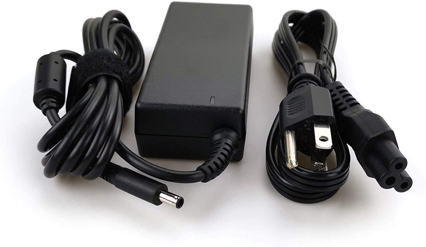 Dell adapter plugged into Inspiron laptop providing steady power during use