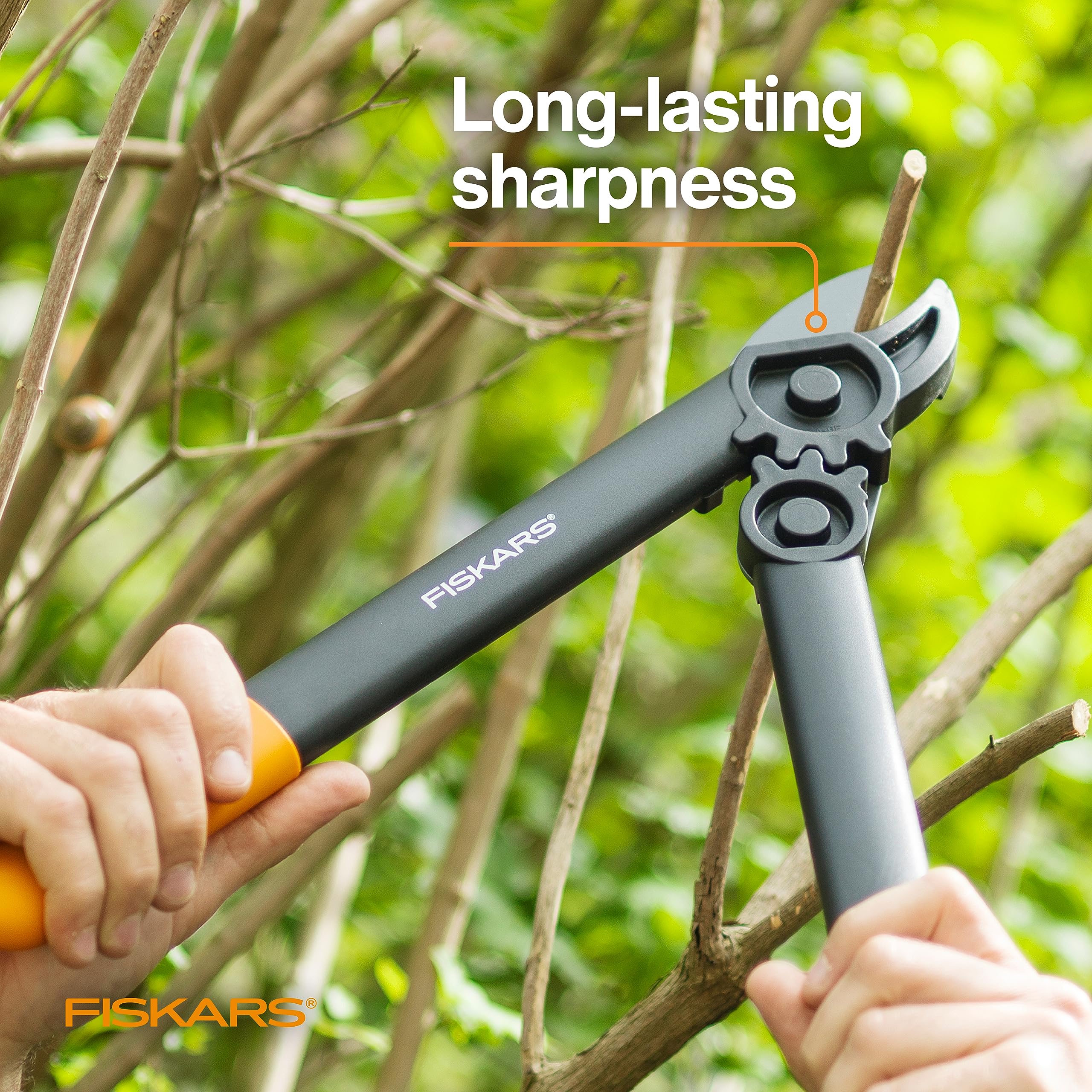 Fiskars loppers cutting a shrub branch illustrating clean 1.25-inch capacity cuts