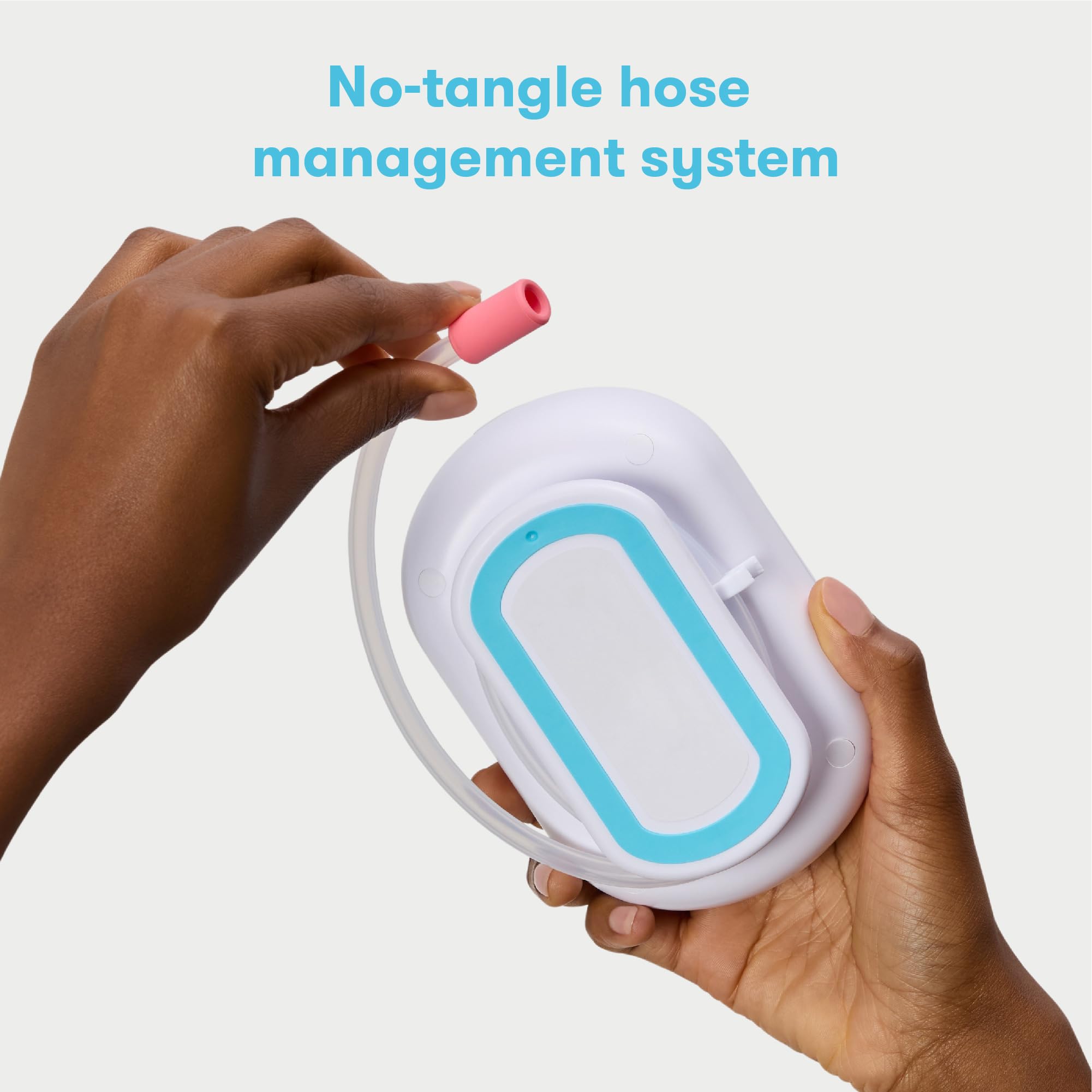 Frida Electric NoseFrida Pro comparación de tamaño con mano, compacto y portátil