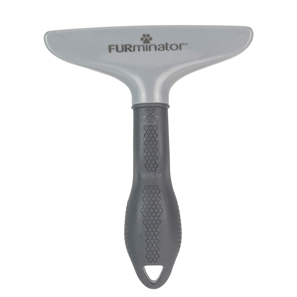 FURminator en uso cepillando gato para reducir pelo suelto