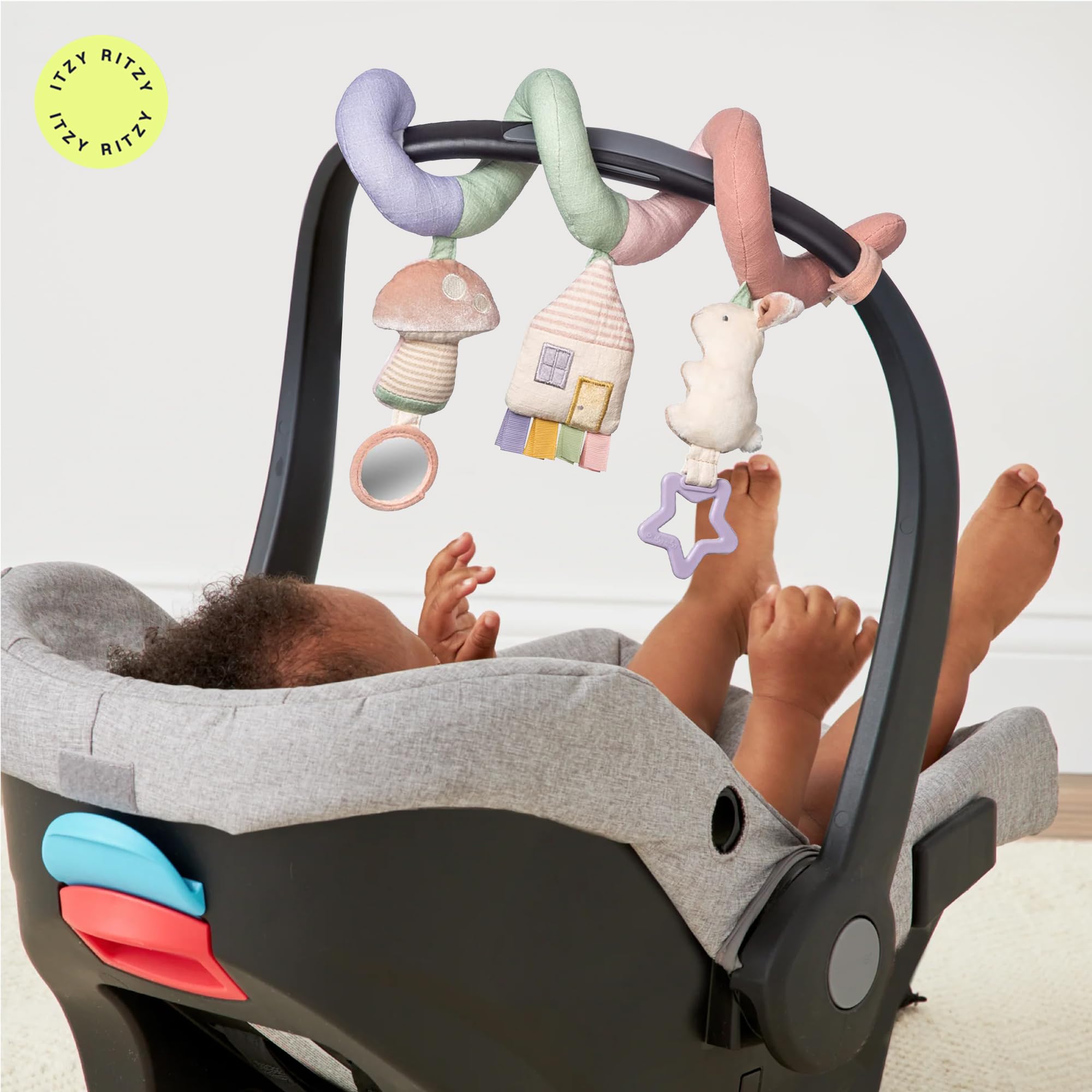 Itzy Ritzy spiral in lifestyle scene with smiling baby enjoying stimulation