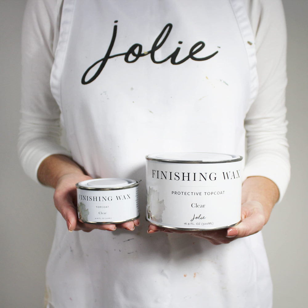 Jolie applying wax with brush to cabinet demonstrating even coverage