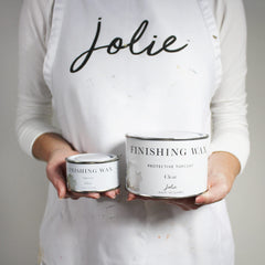 Jolie applying wax with brush to cabinet demonstrating even coverage