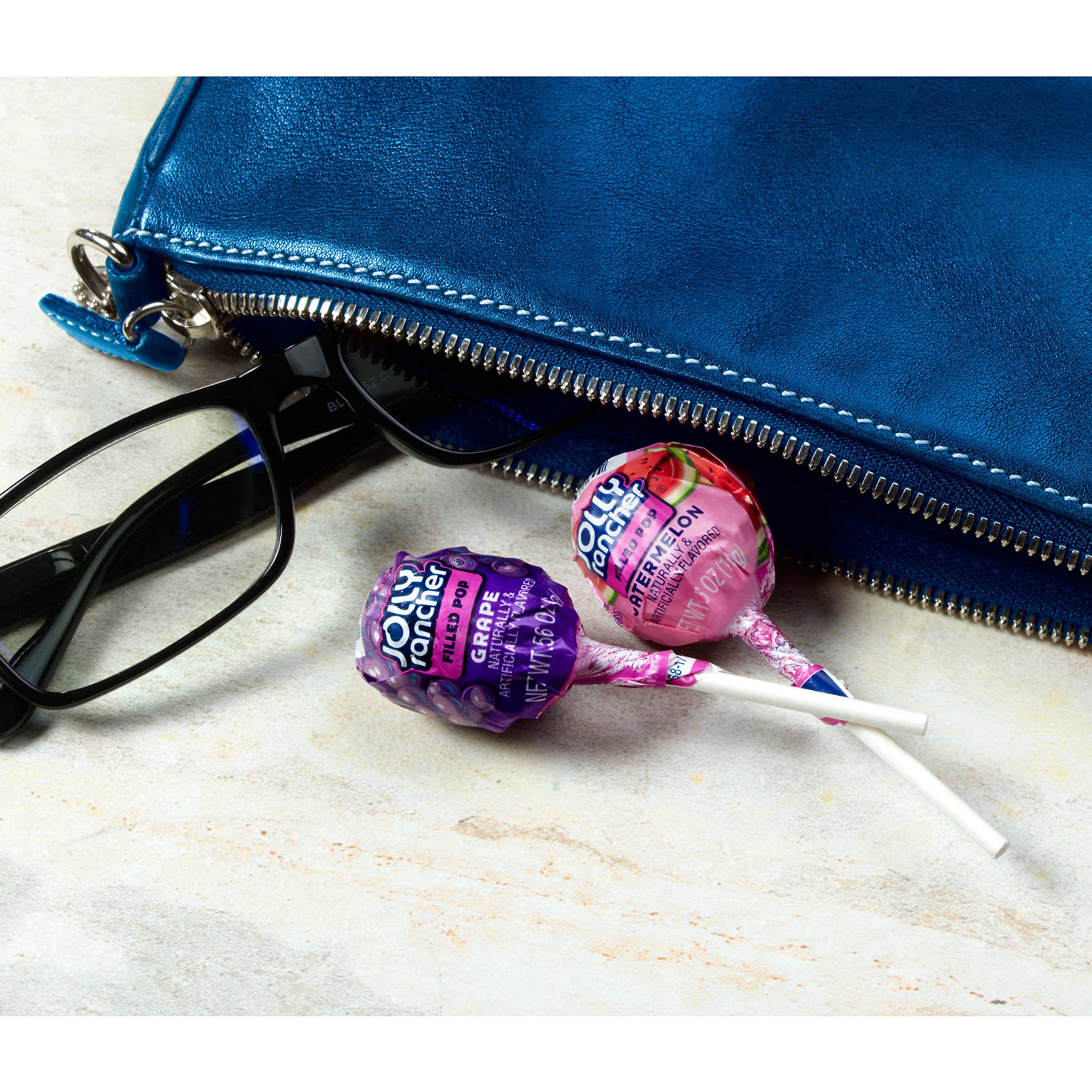 JOLLY RANCHER paleta junto a monedas para comparar tamaño fácilmente