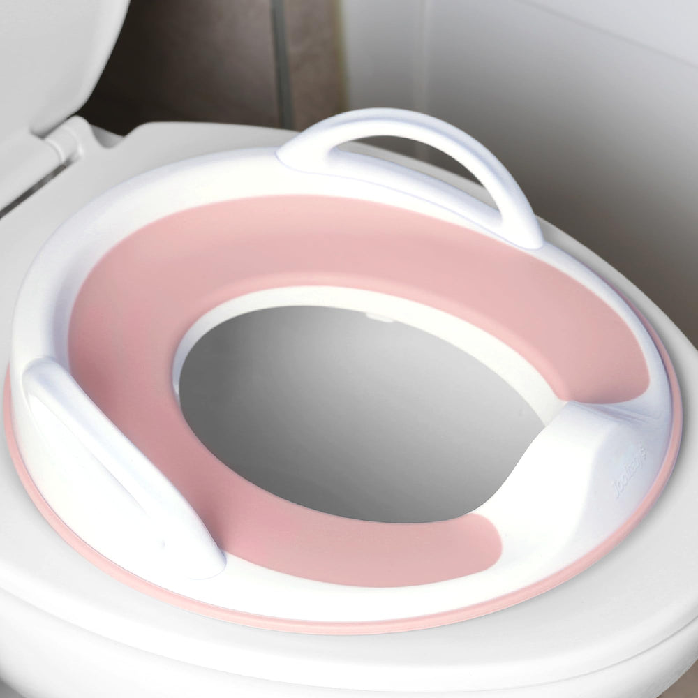 Jool Baby asiento delantero rosa colocado en inodoro mostrando seguridad y confort