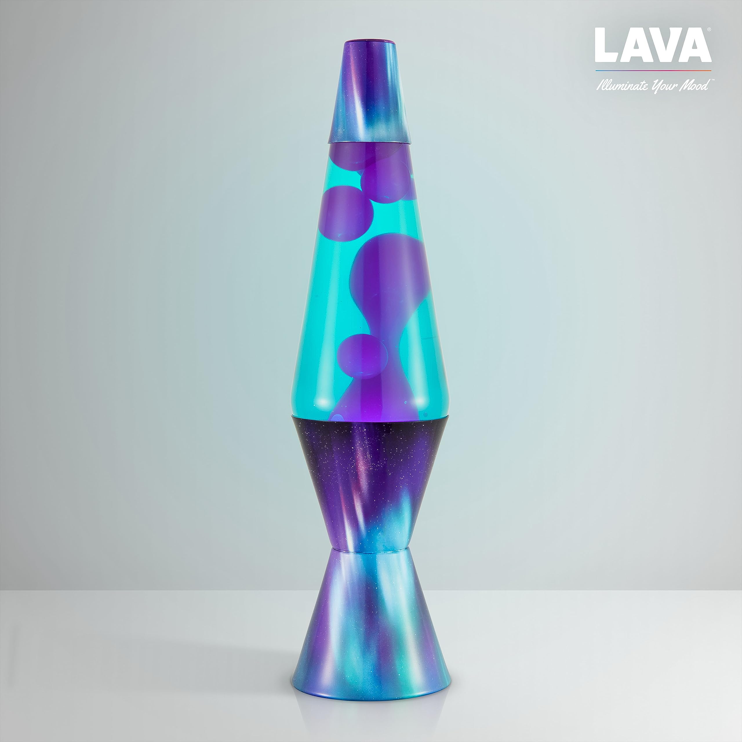 Lava Lite junto a libro para comparación de tamaño y escala práctica