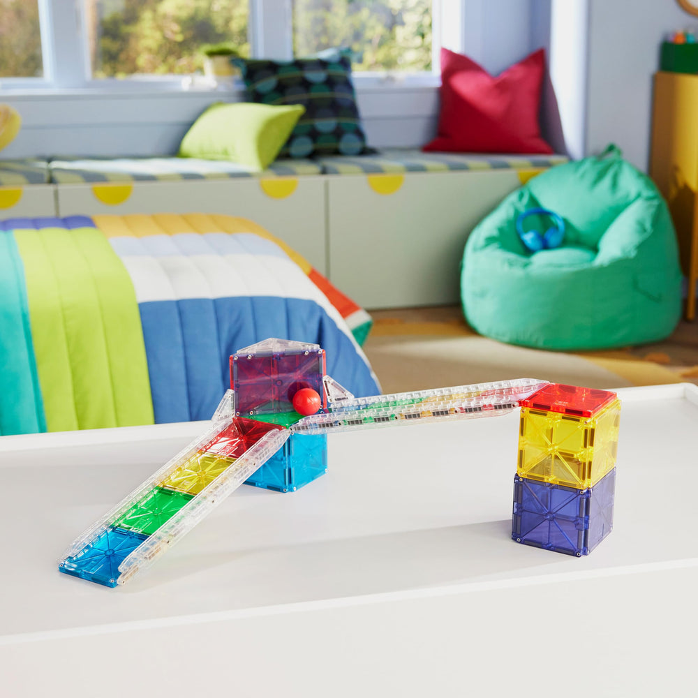 MAGNA-TILES rails in use extending a racetrack for longer runs and speed