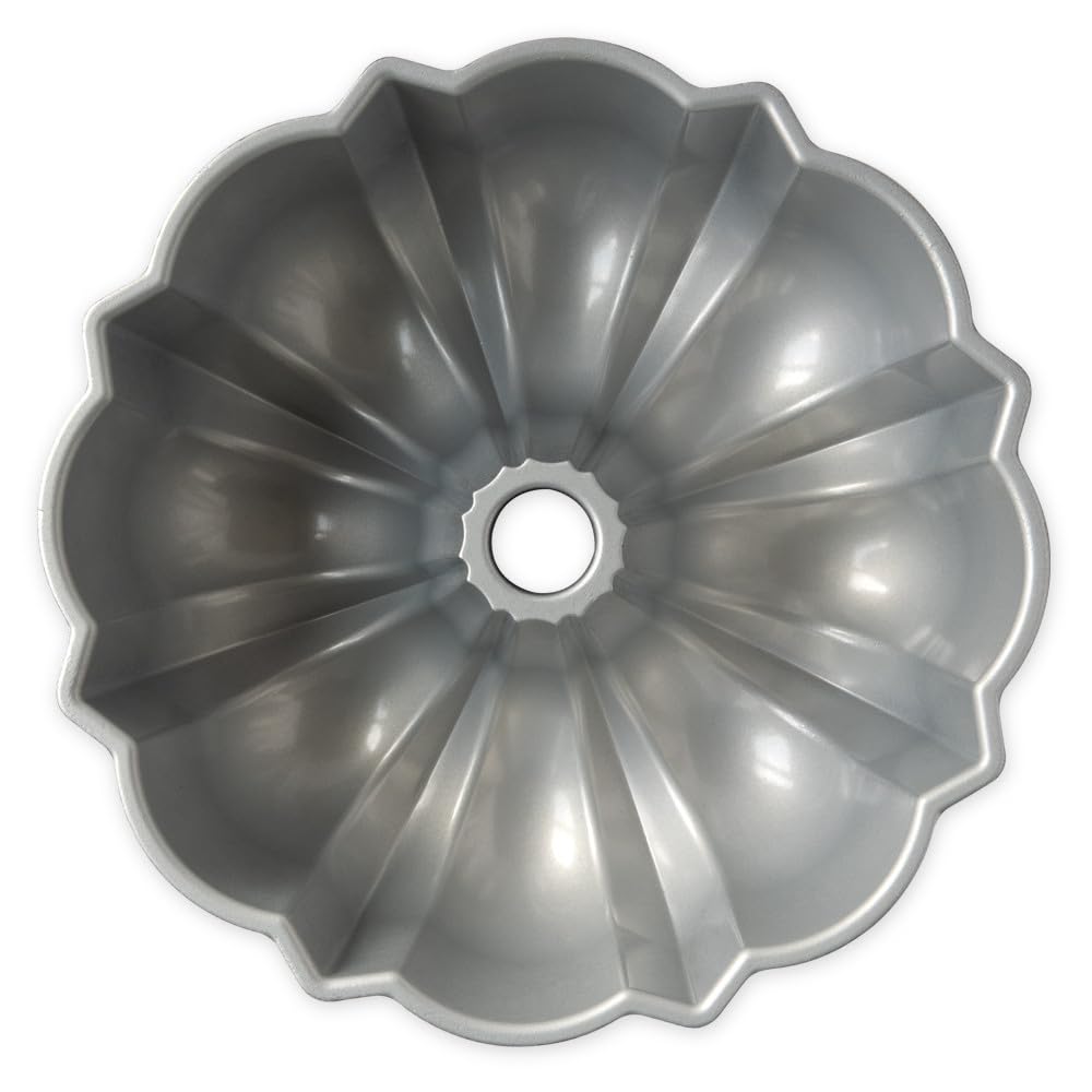 Nordic Ware Bundt pan beside measuring cup for scale and 12-cup capacity clarity