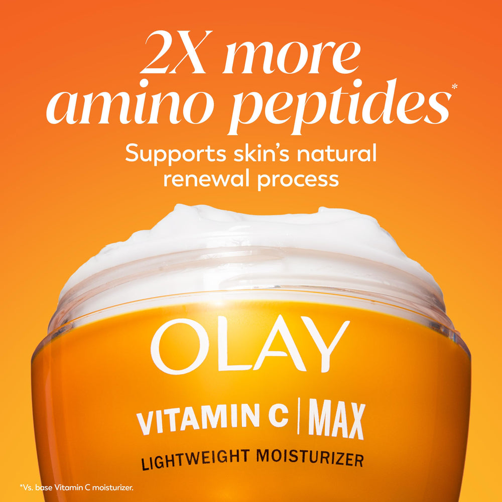 Olay producto sobre mesa con frutas cítricas evocando fragancia fresca