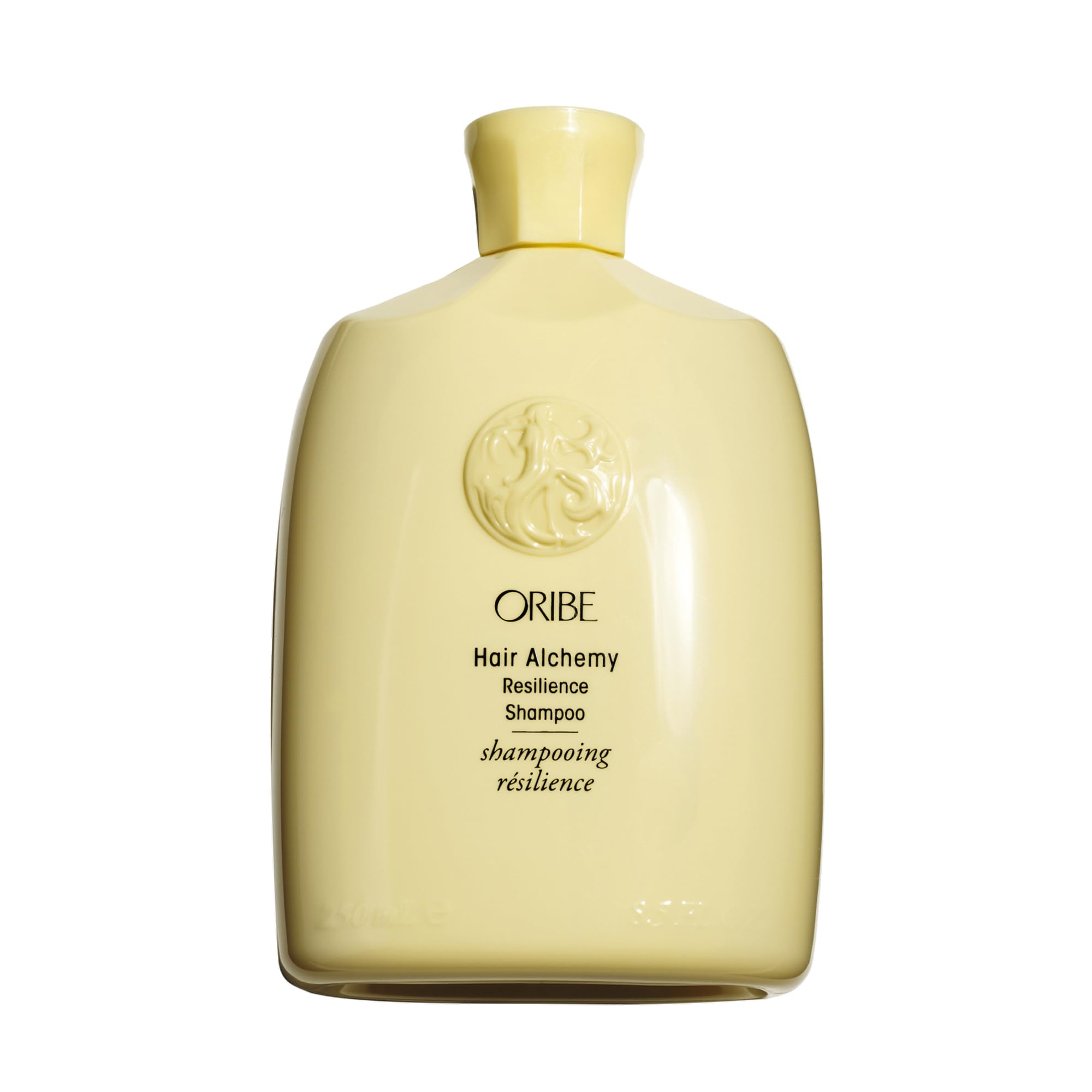 Oribe Hair Alchemy frontal mostrando botella elegante y beneficio fortalecedor