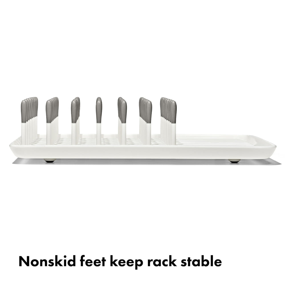 OXO Tot drying rack loaded with bottles demonstrating upright airflow benefit