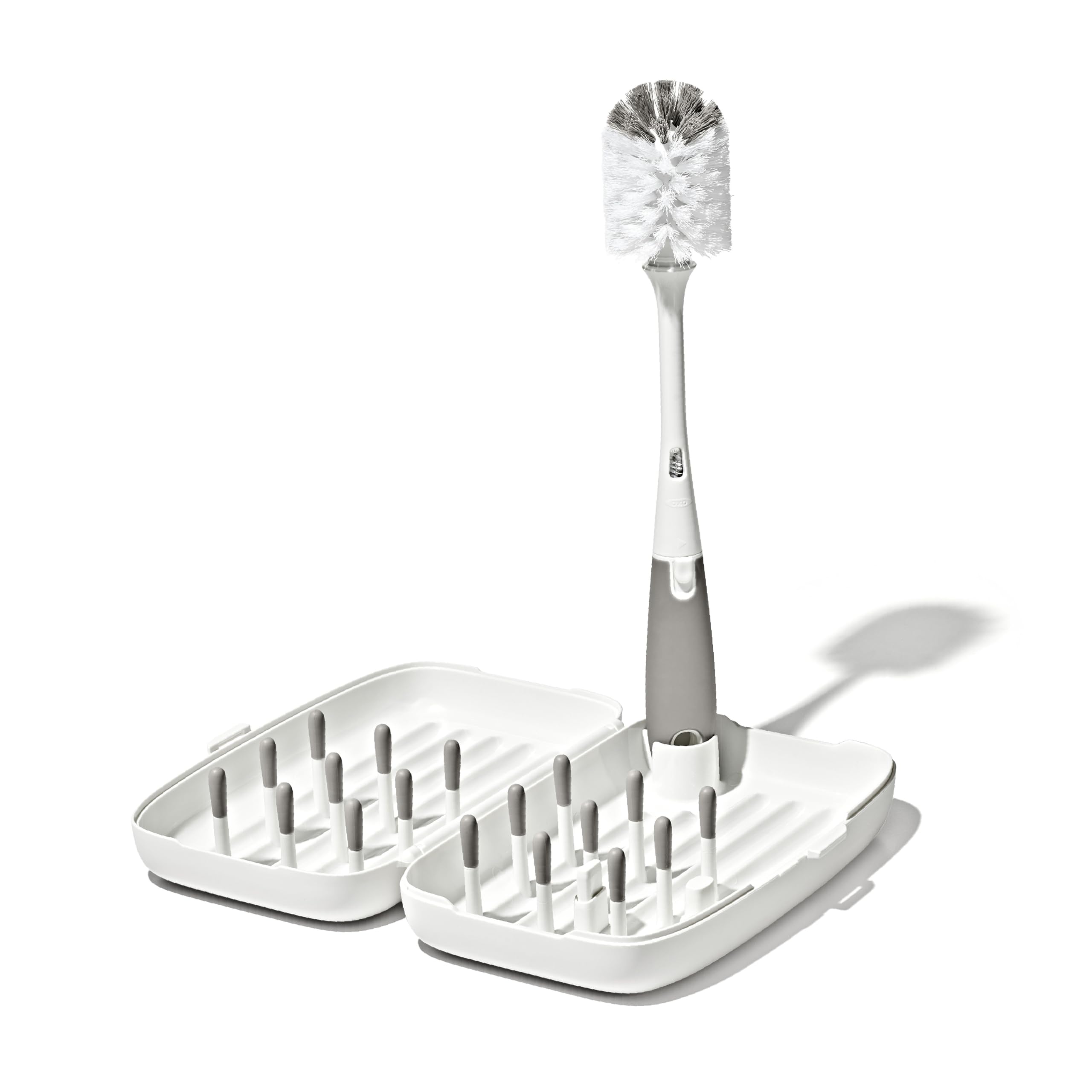 OXO Tot front view of compact travel drying rack showing organized bottles and pegs