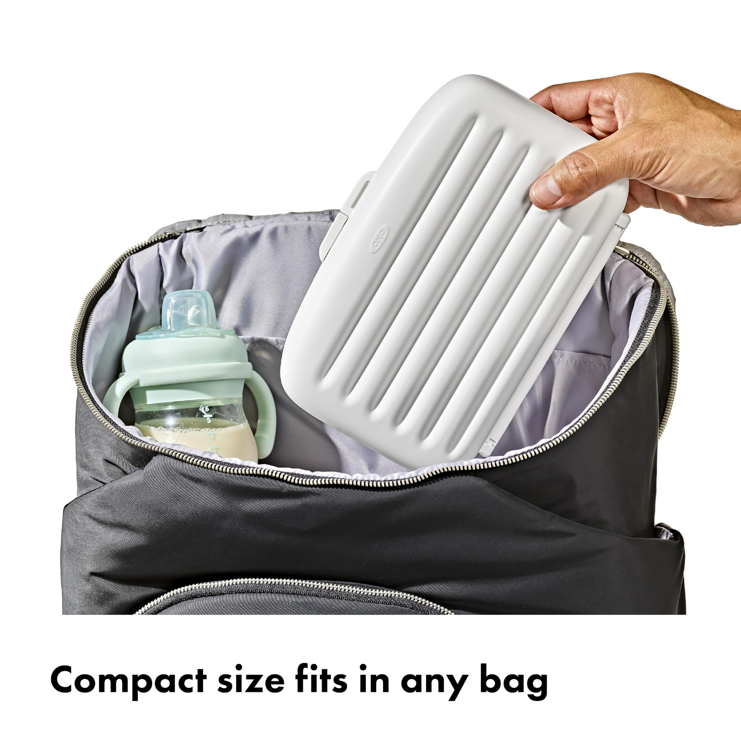 OXO Tot tray folded flat to show compact travel-ready profile and easy packing