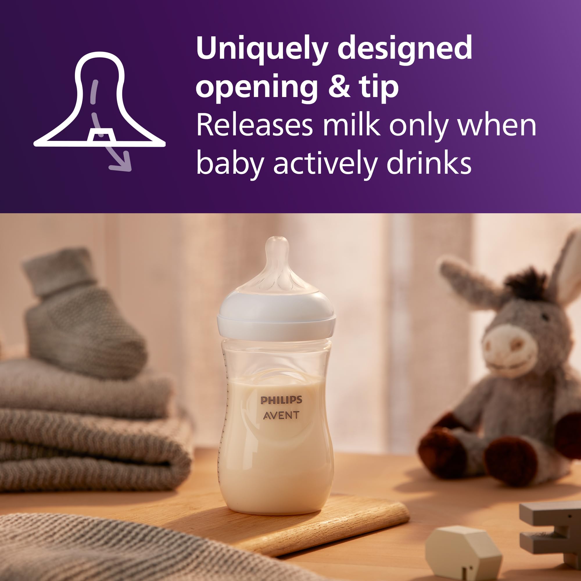 Philips Avent biberón en mano de adulto demostrando ergonomía y comodidad al sujetar