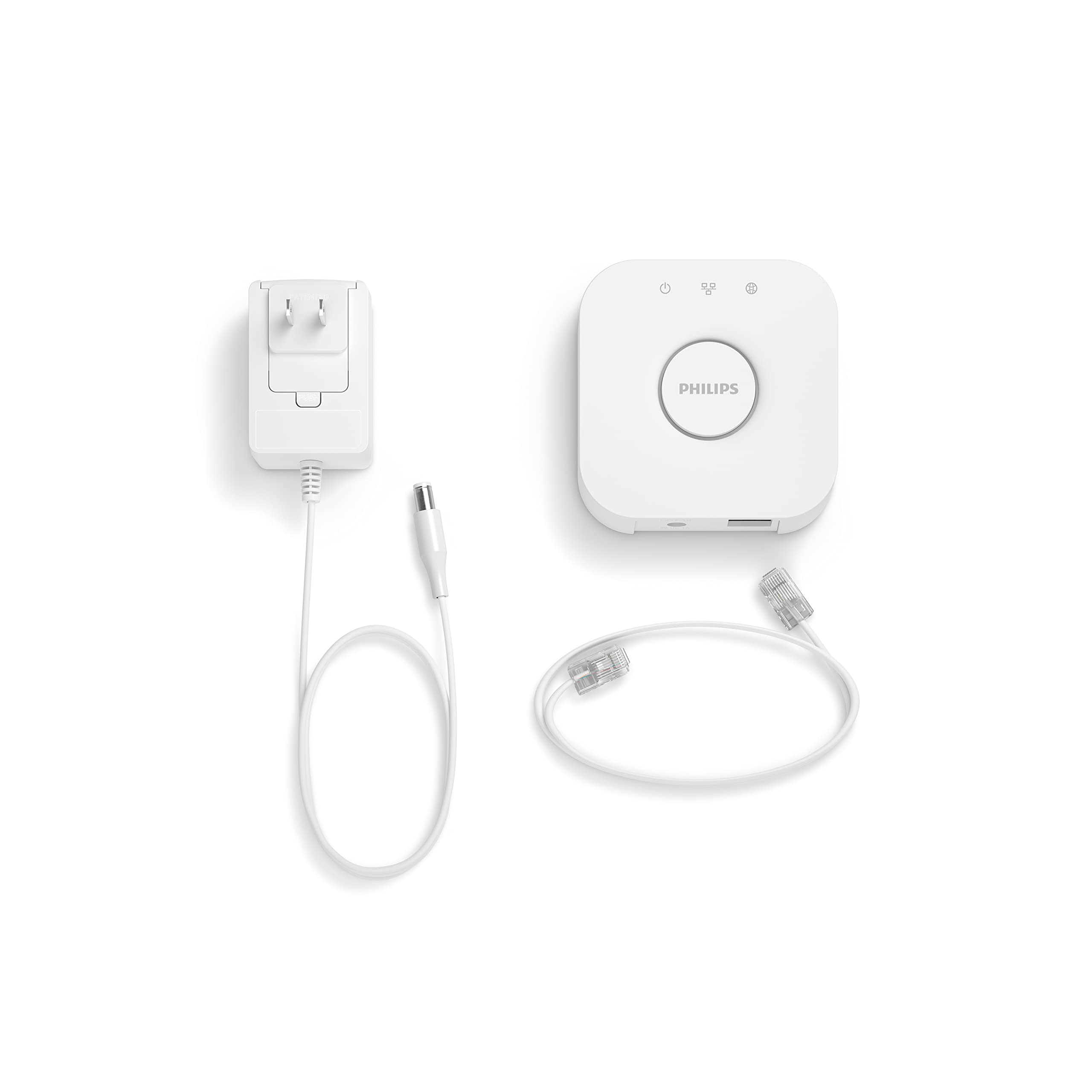 Philips Hue Bridge junto a smartphone mostrando la app y control remoto Hue