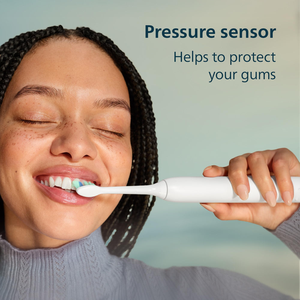 Philips Sonicare comparación de tamaño junto a un cepillo manual