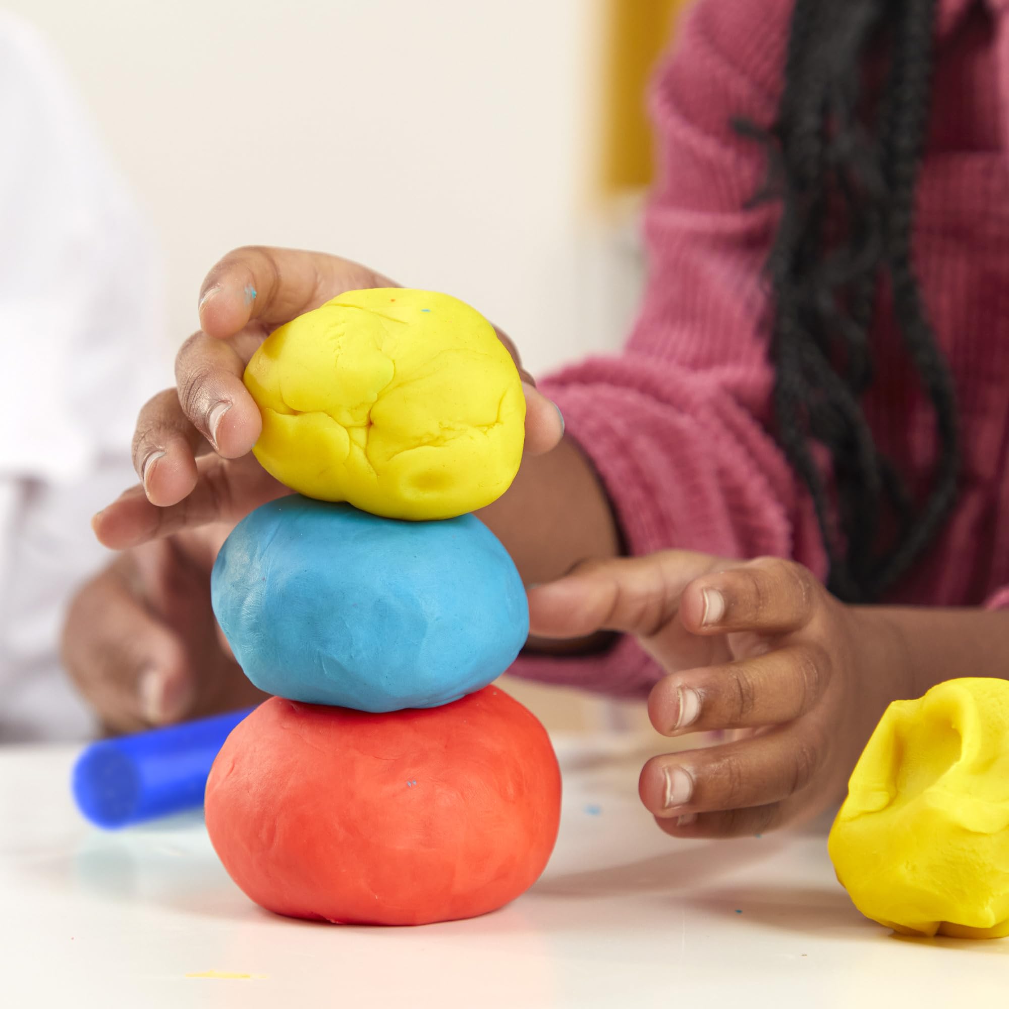 Play‑Doh 1‑ounce can beside coin for size comparison and portion clarity