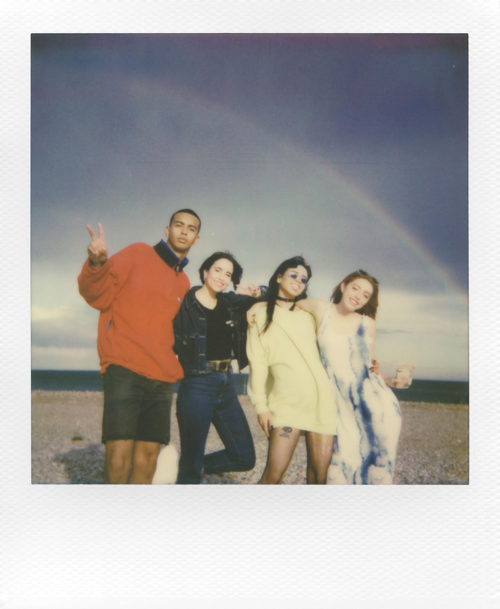 Polaroid film exiting a 600 camera mid-eject demonstrating instant development in use
