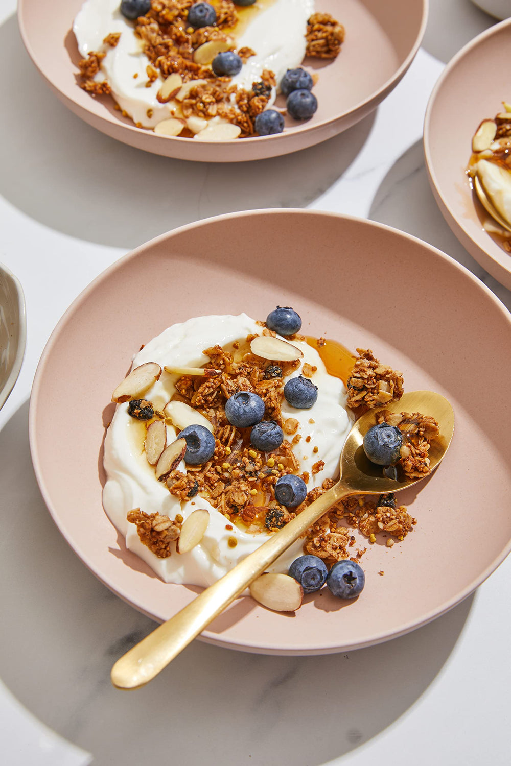 Purely Elizabeth breakfast table with granola, cereal bowl and fresh fruit appeal
