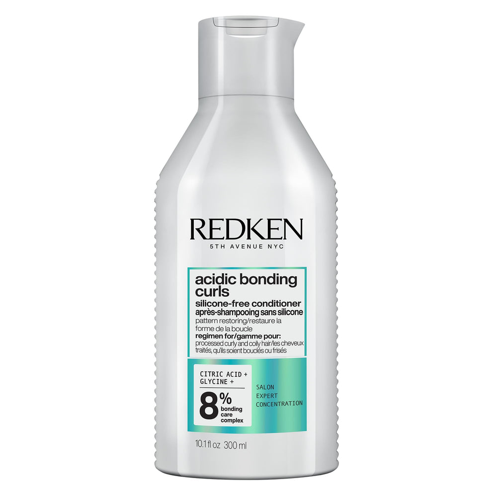 Redken frasco frontal del acondicionador mostrando marca y formato 300 ml