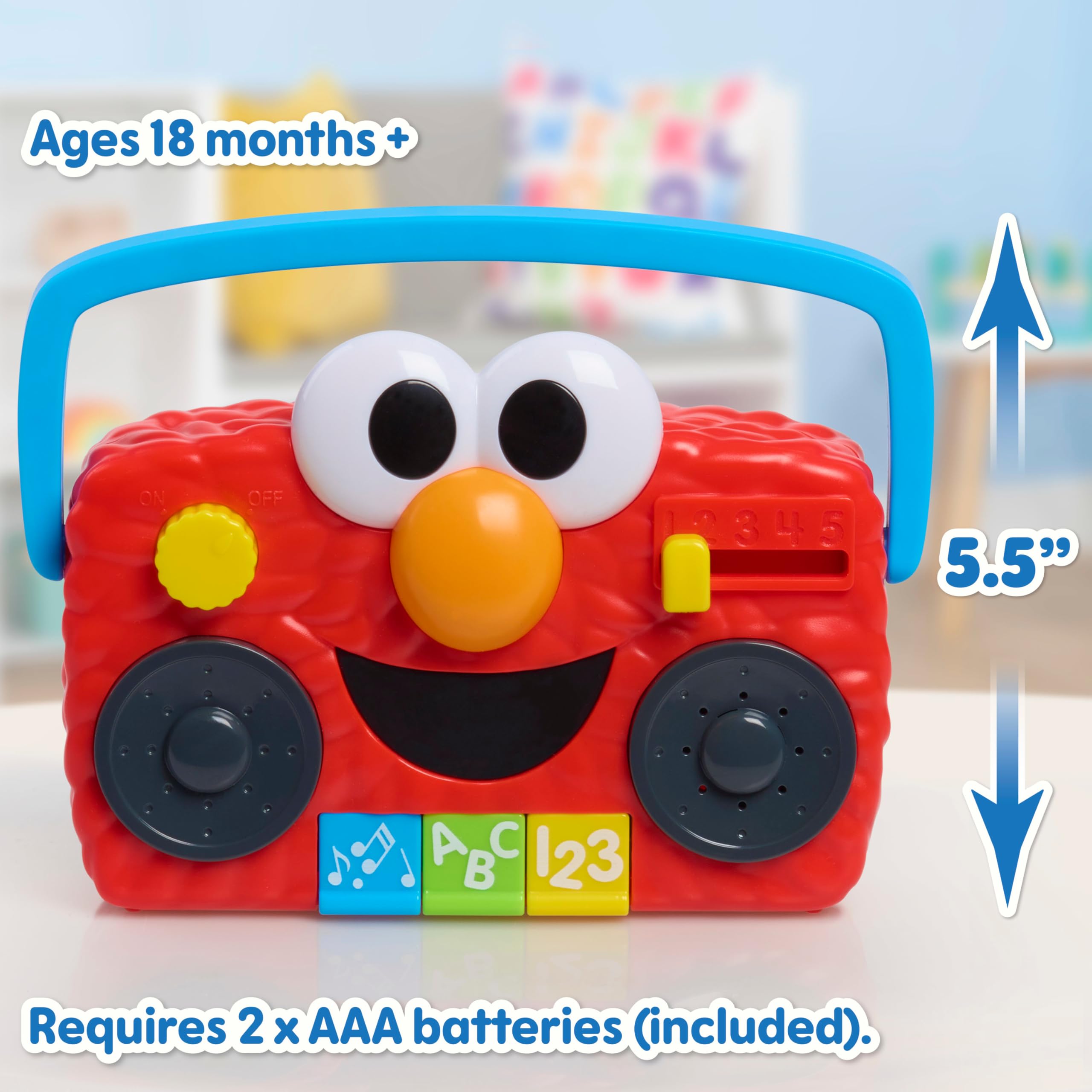 Sesame Street Elmo boombox junto a una regla para comparar tamaño portátil