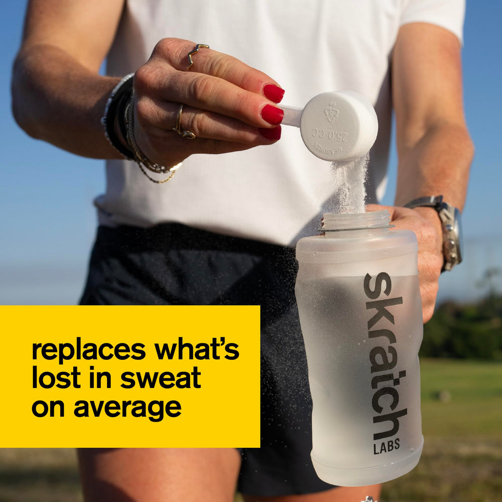 Skratch Labs tub open with powder visible, easy scoop access benefit