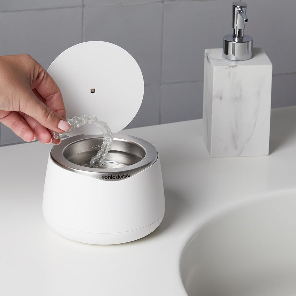 Sonic Dental next to ruler for scale, compact size fits small bathroom counters
