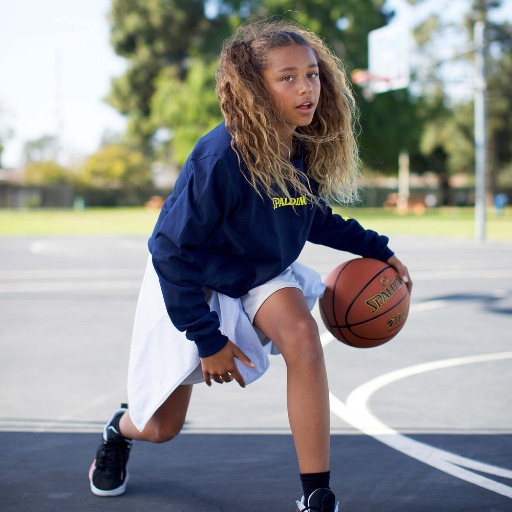 Spalding escena callejera con jugador usando el balón en cancha
