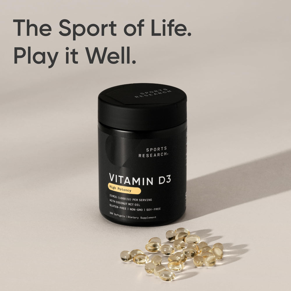 Sports Research softgels sobre mesa de cocina junto a alimento con grasa