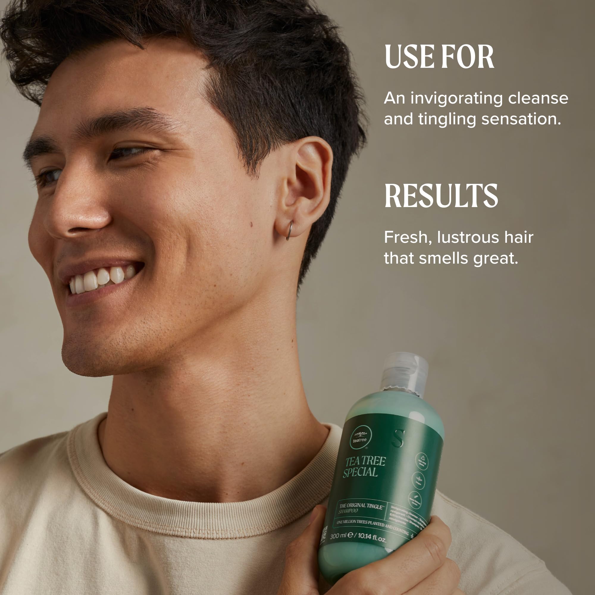 Tea Tree comparativa tamaño 16.9 fl oz frente a mano para escala