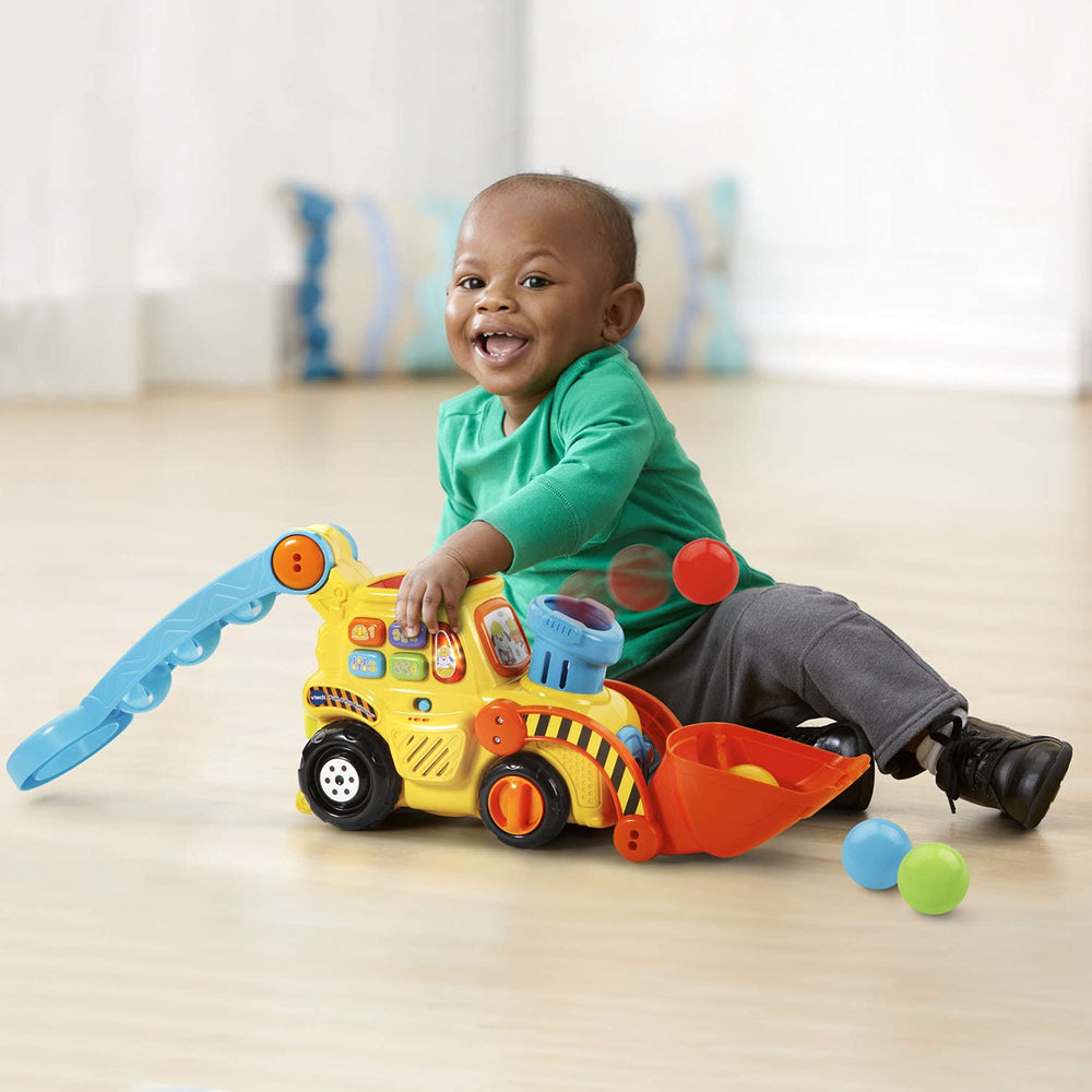 VTech bulldozer rodando por el suelo activando música, estimula caminar