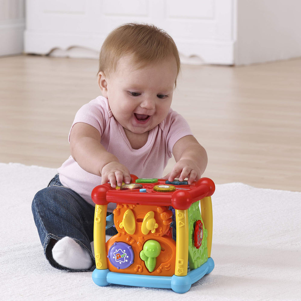 VTech cube beside a toy block to show compact size and portability