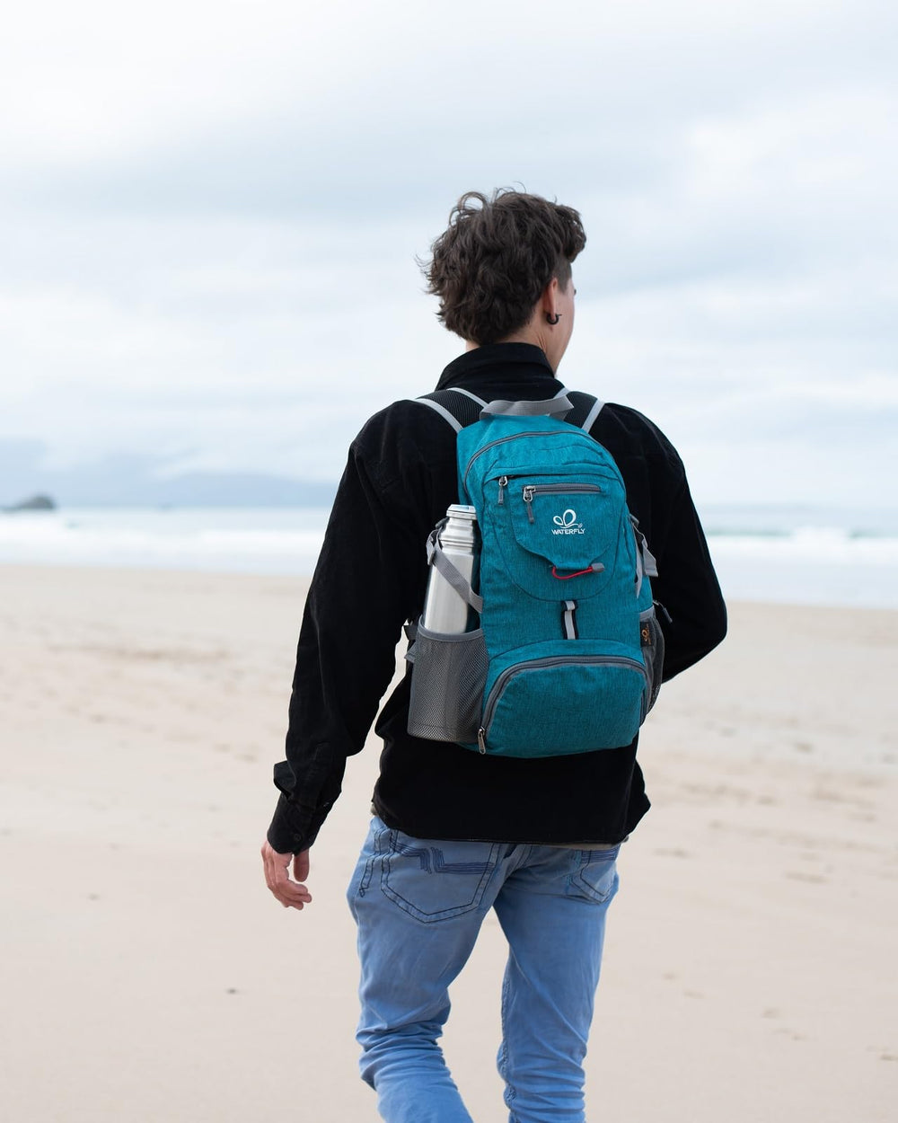 WATERFLY backpack worn by hiker in nature showing lightweight comfort and mobility